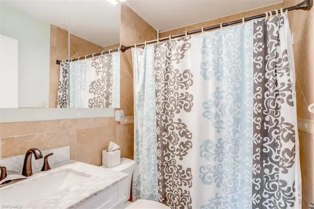 a bathroom with a sink and a shower curtain