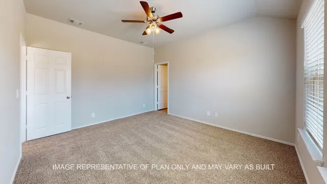 an empty room with windows and a ceiling fan