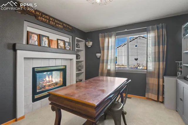 a dining room with a fireplace and a table