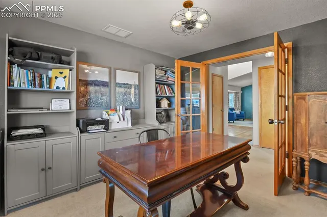 a kitchen with a table chairs refrigerator and cabinets