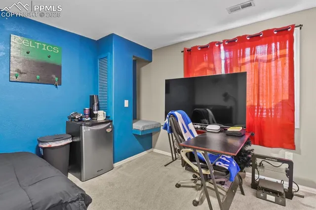 a living room with furniture a flat screen tv and a window