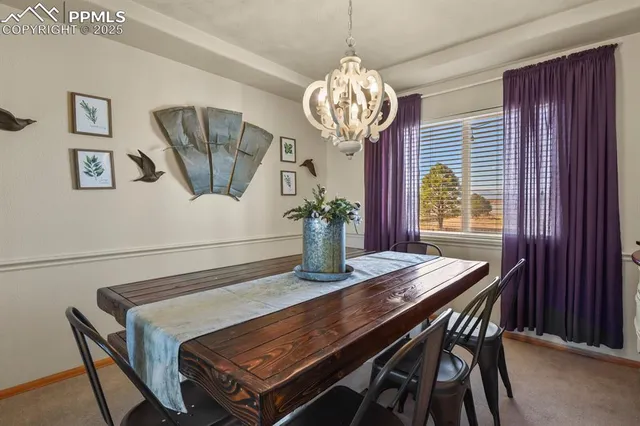a view of a dining room with furniture wooden floor and chandelier