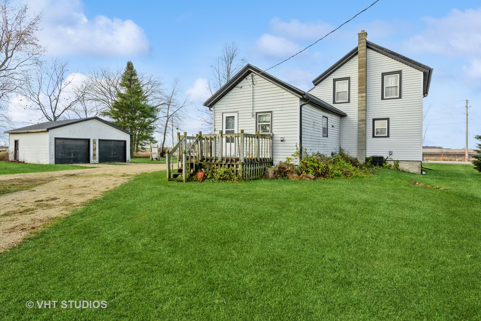 N1506 County C Road Sharon, WI 53585 - Photo 2 of 19 a front view of a house with garden