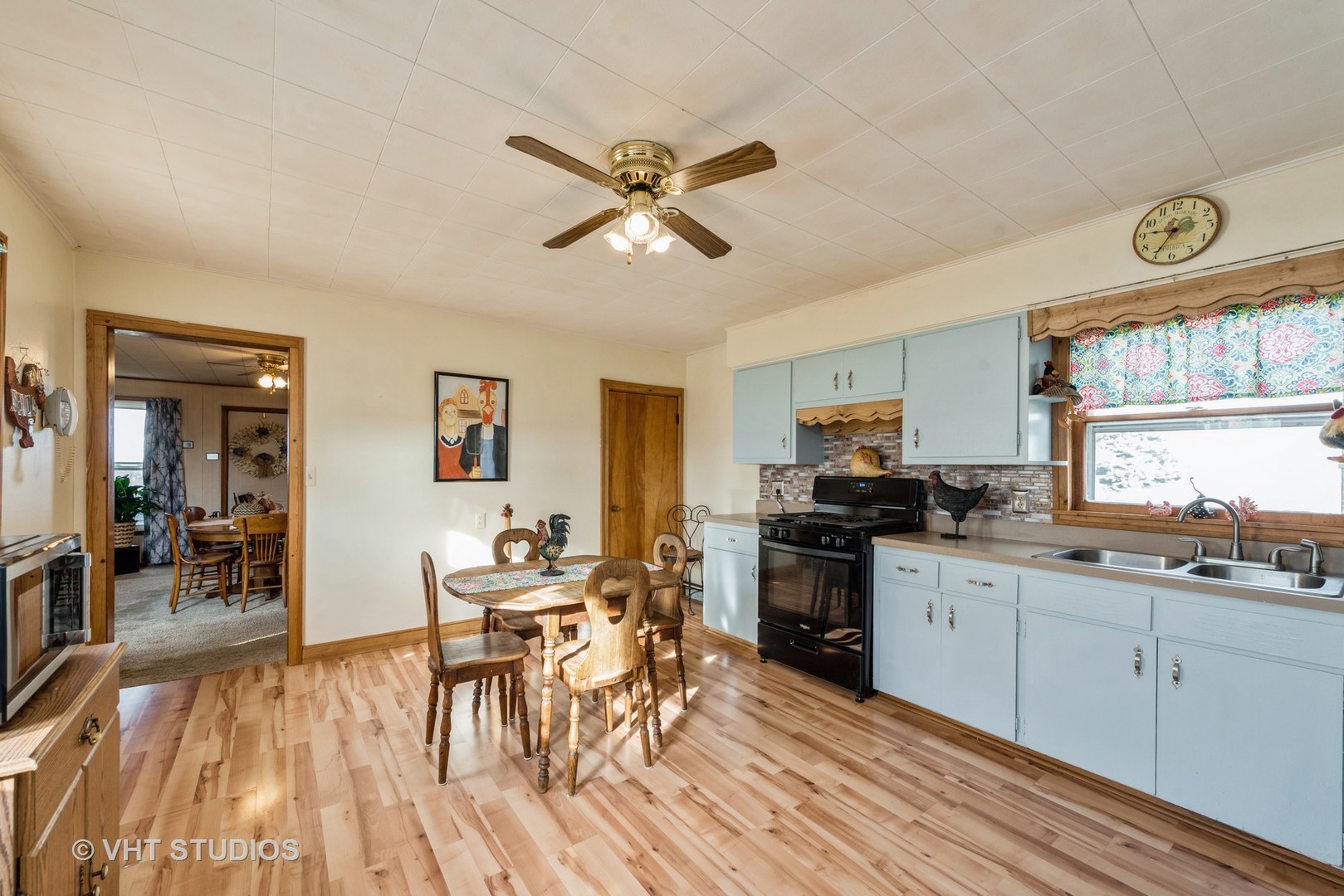N1506 County C Road Sharon, WI 53585 - Photo 4 of 19 a kitchen with stainless steel appliances granite countertop a stove top oven a sink a dining table and chairs with wooden floor