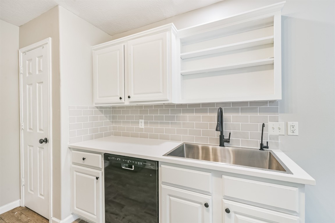 16468 Ryan Guinn Way Conroe, TX 77303 - Photo 11 of 31 a kitchen with white cabinets and a sink