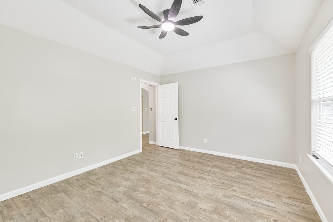 16468 Ryan Guinn Way Conroe, TX 77303 - Photo 16 of 31 an empty room with a window and ceiling fan
