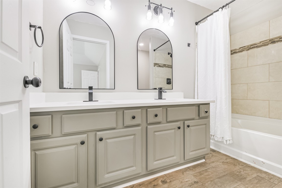 16468 Ryan Guinn Way Conroe, TX 77303 - Photo 19 of 31 a bathroom with a double vanity sink and a mirror