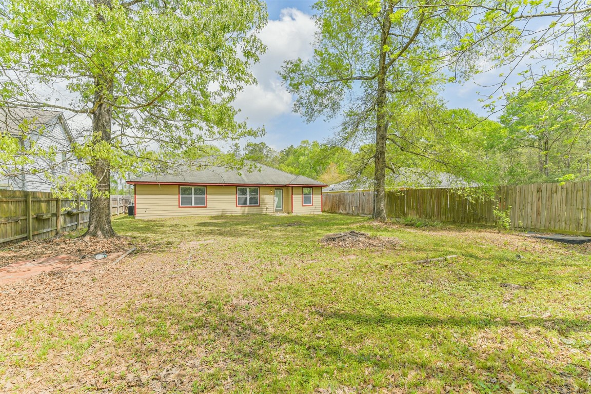 16468 Ryan Guinn Way Conroe, TX 77303 - Photo 29 of 31 a front view of a house with a garden