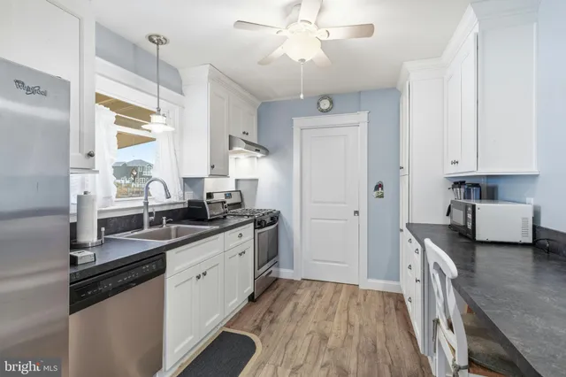 a kitchen with stainless steel appliances a stove a refrigerator and cabinets