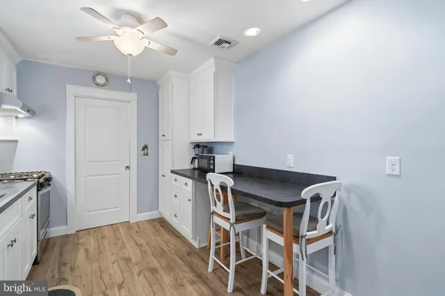 a kitchen with granite countertop a sink stainless steel appliances and cabinets