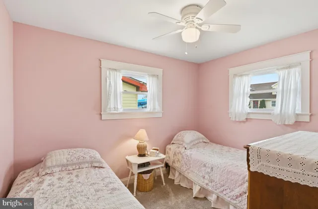 a bedroom with a bed and a lamp on dresser