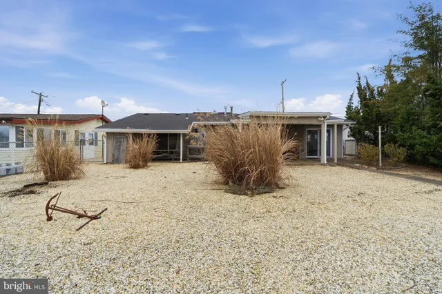 a view of a house with backyard porch and sitting area