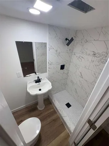 a bathroom with a tub sink a toilet and vanity