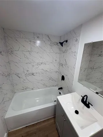 a white toilet sitting next to a bath tub