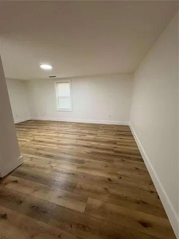 an empty room with wooden floor