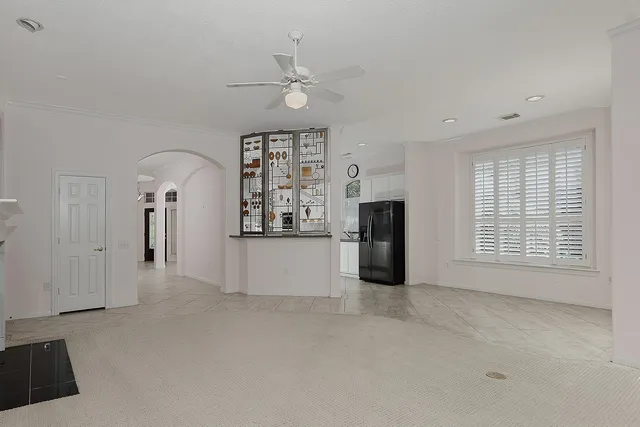 a view of an empty room with a kitchen