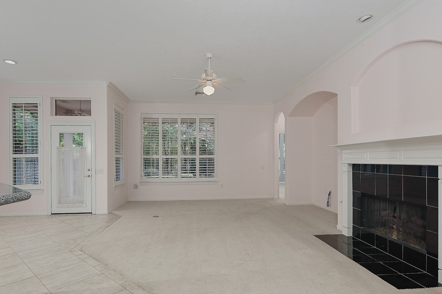 7 Sovereign Way Conroe, TX 77384 - Photo 13 of 47 an empty room with windows and fireplace