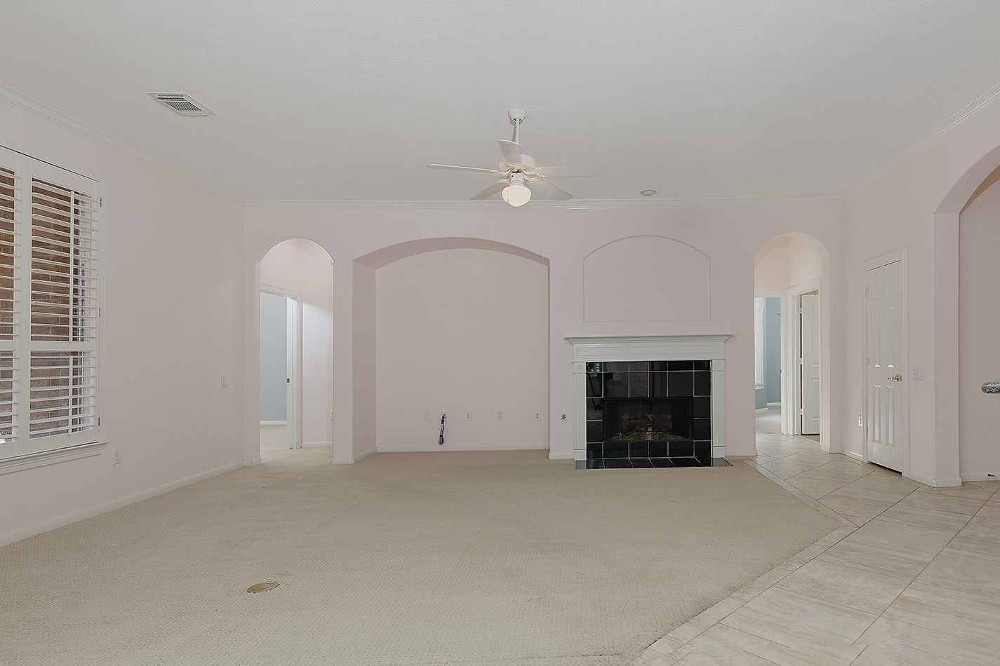 7 Sovereign Way Conroe, TX 77384 - Photo 14 of 47 an empty room with windows and fireplace