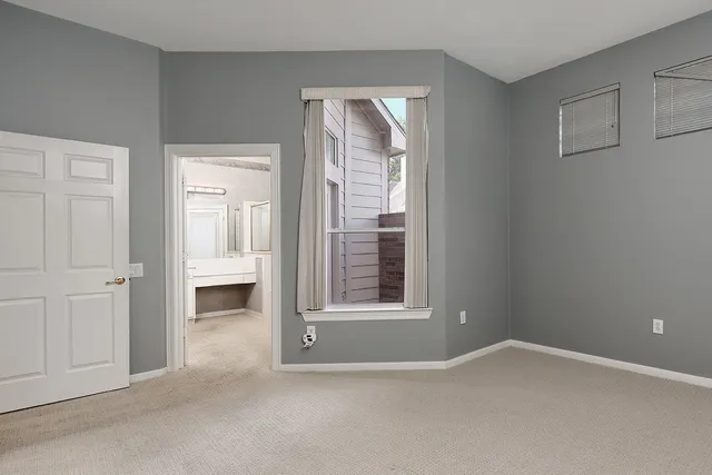 an empty room with windows and closet