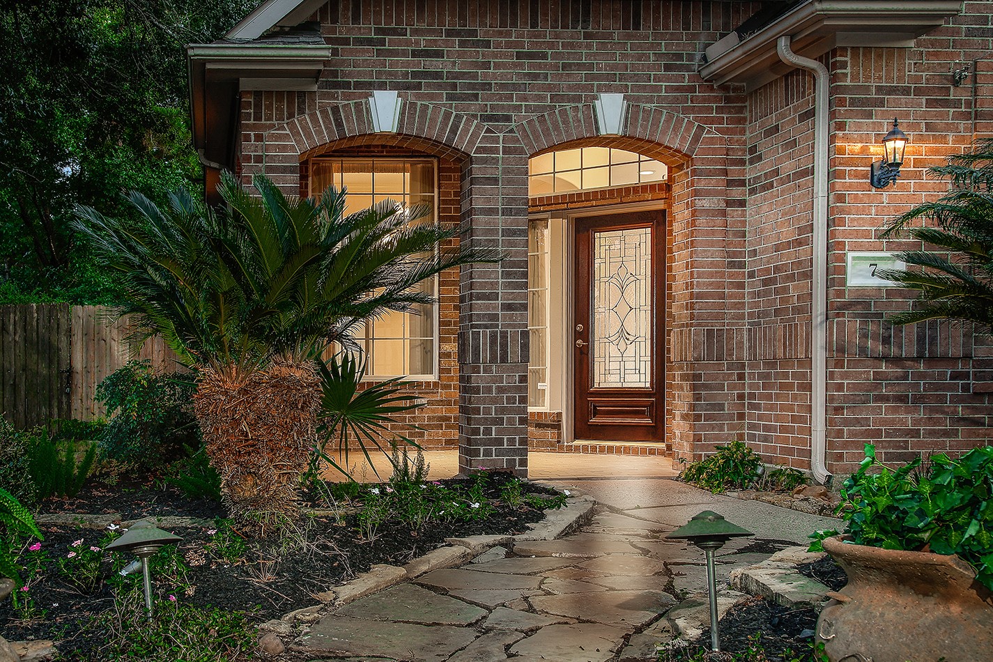 7 Sovereign Way Conroe, TX 77384 - Photo 2 of 47 a front view of a house with garden