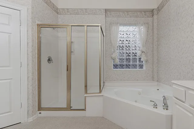 a bathroom with a bathtub and shower