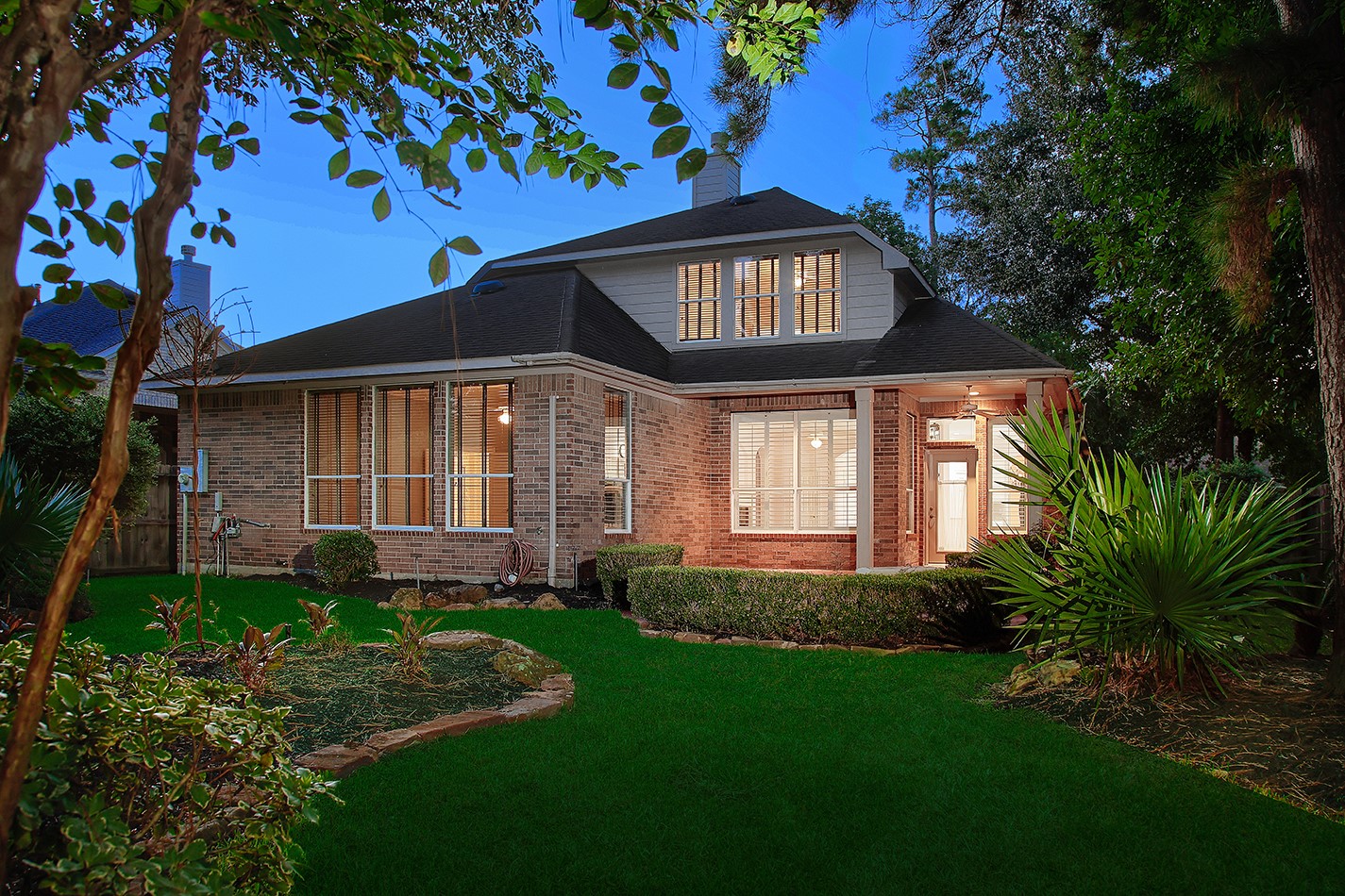 7 Sovereign Way Conroe, TX 77384 - Photo 28 of 47 a front view of a house with garden