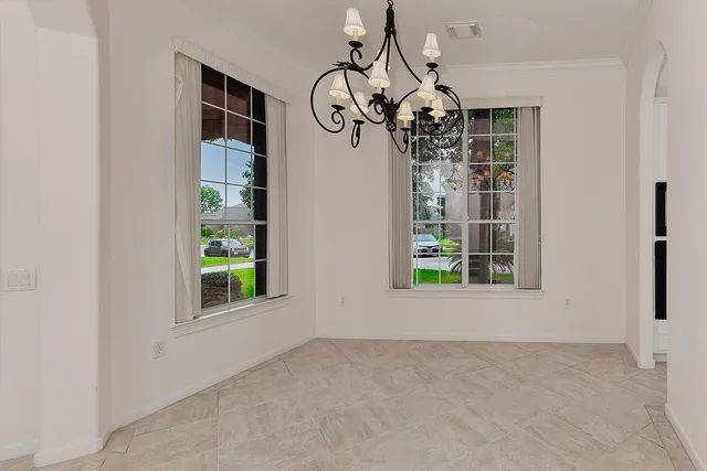 a view of a room with windows and chandelier
