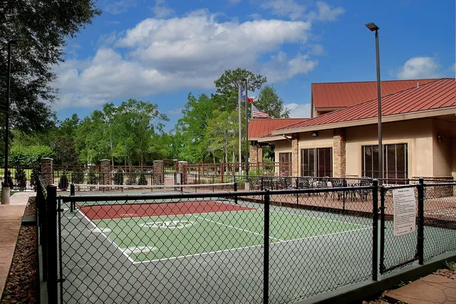 a front view of a house with yard and sitting area