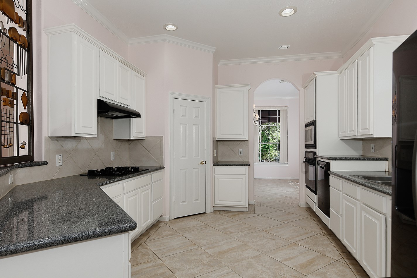 7 Sovereign Way Conroe, TX 77384 - Photo 9 of 47 a kitchen with white cabinets and appliances