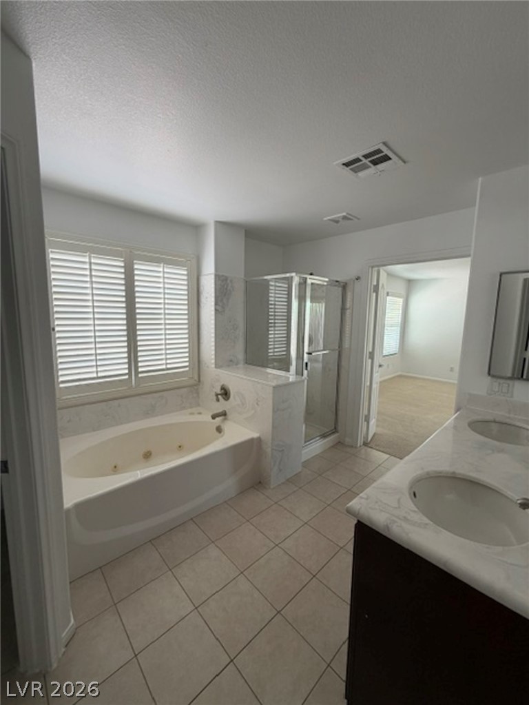 3862 Landing Ridge Place Las Vegas, NV 89135 - Photo 15 of 26 Indulge in a tranquil primary bathroom with a luxurious soaking tub and a spacious glass-enclosed shower.