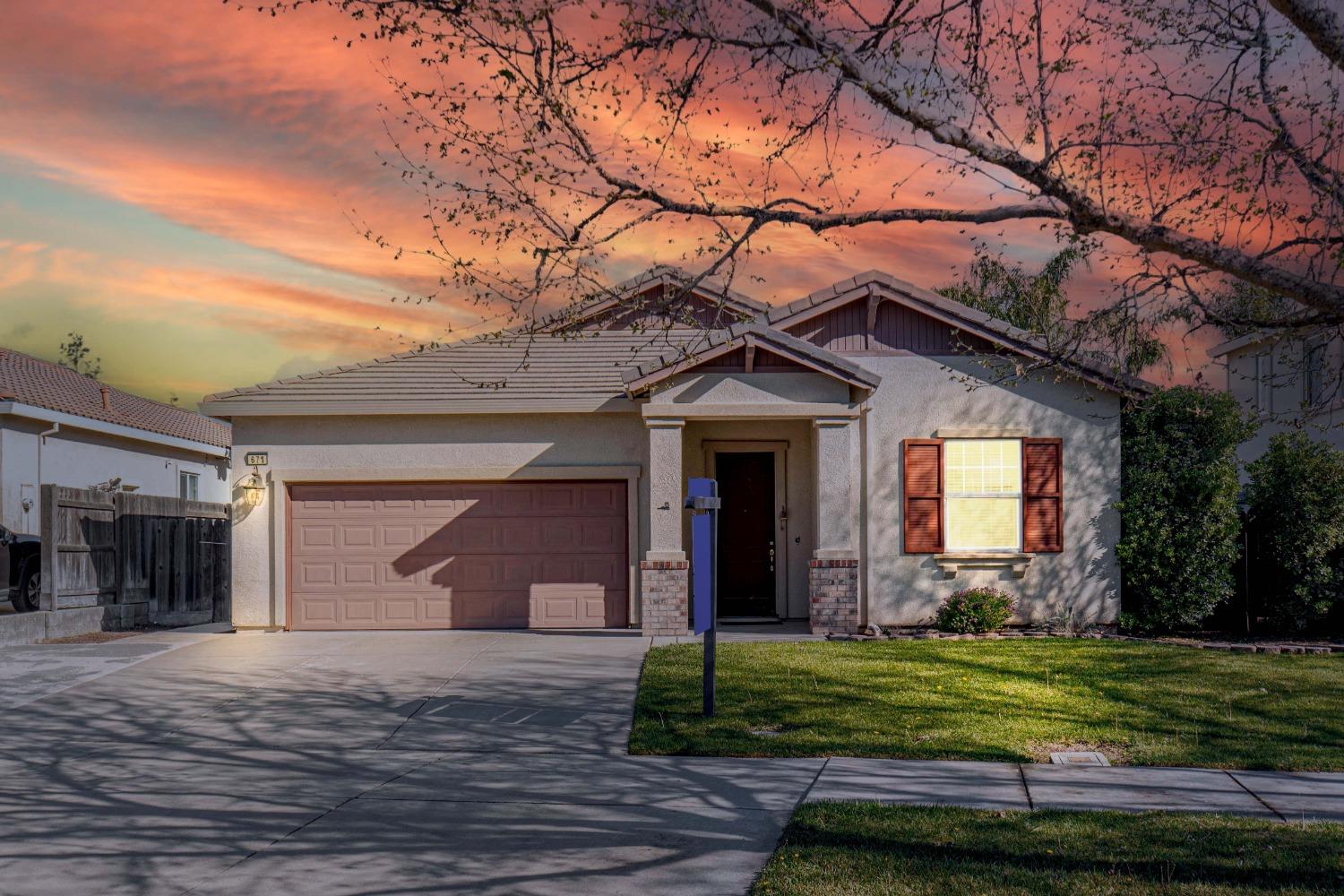 671 Boesch Drive Ripon, CA 95366 - Photo 1 of 1 a front view of a house with a yard and garage