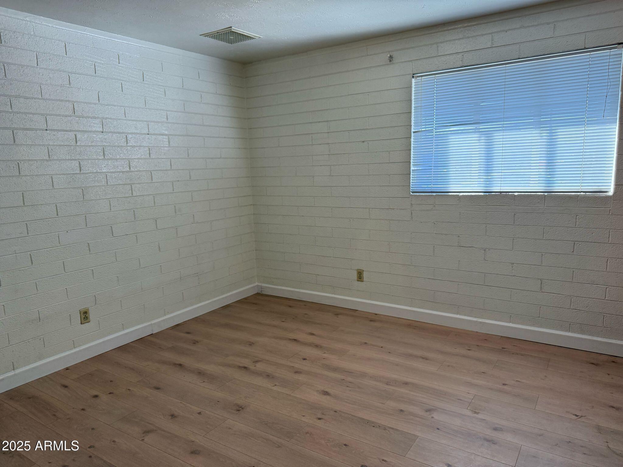 5000 West Osborn Road Phoenix, AZ 85031 - Photo 15 of 23 a view of a small space with wooden floor and a window