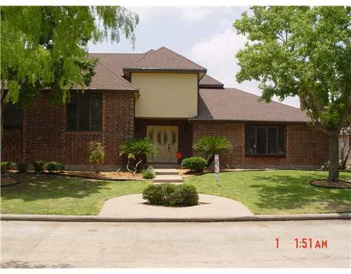 a front view of a house with a yard tree and a yard