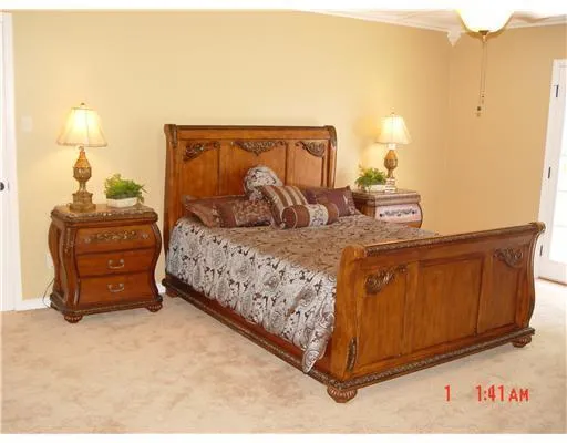a bedroom with a bed and cabinets