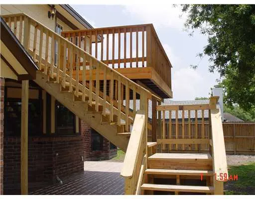 a view of staircase with railing and white walls