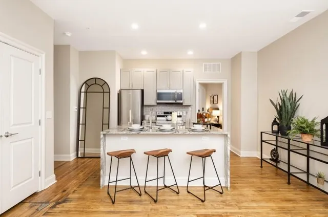 a view of a kitchen with dining table and chairs