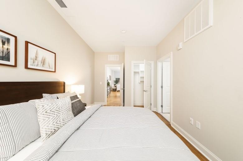 429 Forbes Avenue, Unit 605 Pittsburgh, PA 15219 - Photo 7 of 16 a bedroom with a large bed and a chandelier