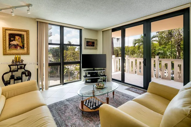 a living room with furniture large window and a flat screen tv