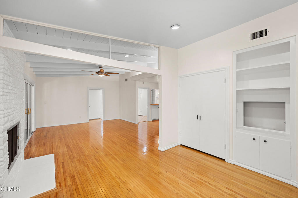 17149 Bullock Street Encino, CA 91316 - Photo 11 of 32 a view of empty room with wooden floor and cabinet