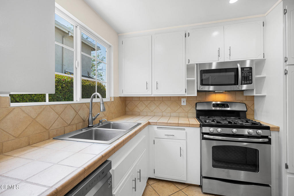 17149 Bullock Street Encino, CA 91316 - Photo 12 of 32 a kitchen that has a sink and a stove