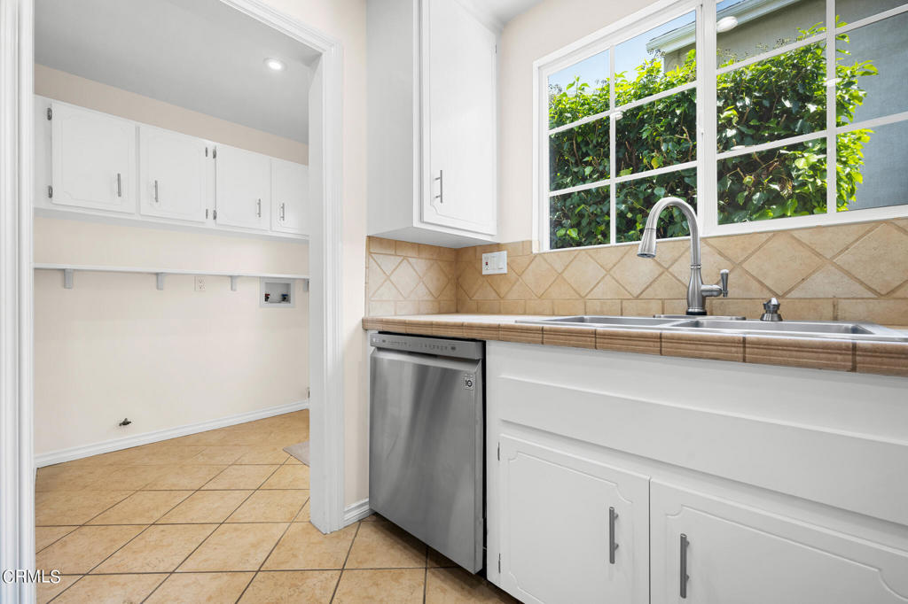 17149 Bullock Street Encino, CA 91316 - Photo 14 of 32 a kitchen with a sink and cabinets