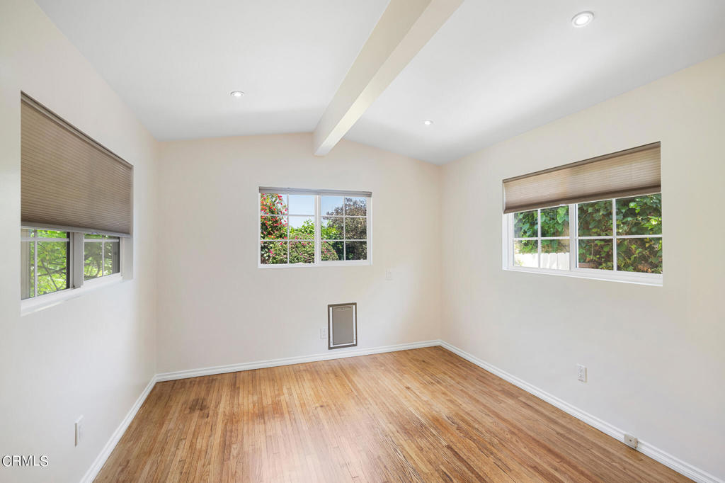 17149 Bullock Street Encino, CA 91316 - Photo 17 of 32 an empty room with wooden floor and windows