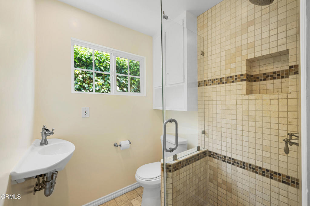 17149 Bullock Street Encino, CA 91316 - Photo 19 of 32 a bathroom with a sink toilet and shower