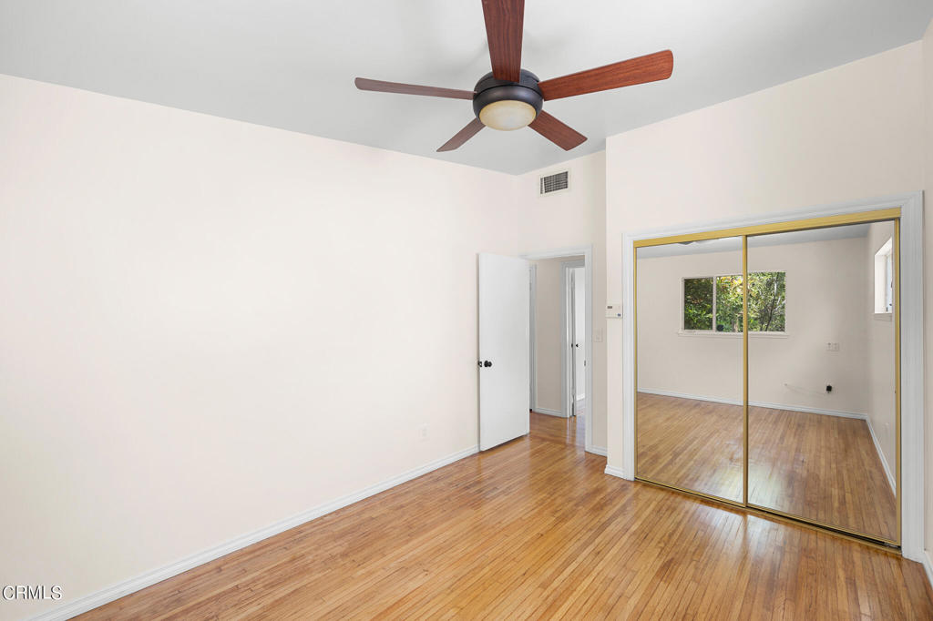 17149 Bullock Street Encino, CA 91316 - Photo 21 of 32 a view of an empty room with wooden floor and a window