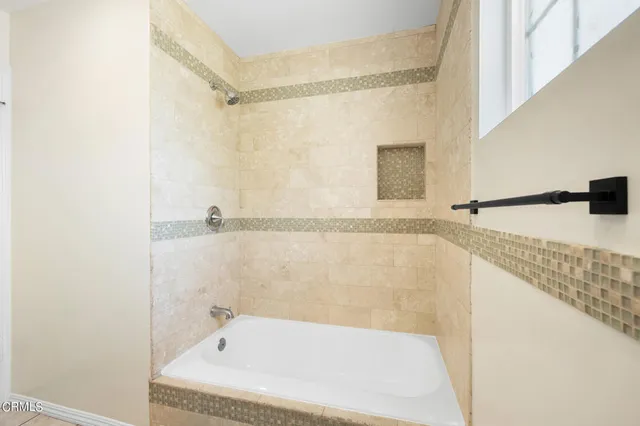 a bathroom with a bathtub and a shower