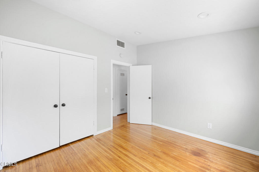17149 Bullock Street Encino, CA 91316 - Photo 25 of 32 a view of an empty room with wooden floor