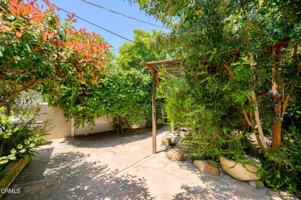 17149 Bullock Street Encino, CA 91316 - Photo 30 of 32 a view of a backyard with table and chairs and potted plants