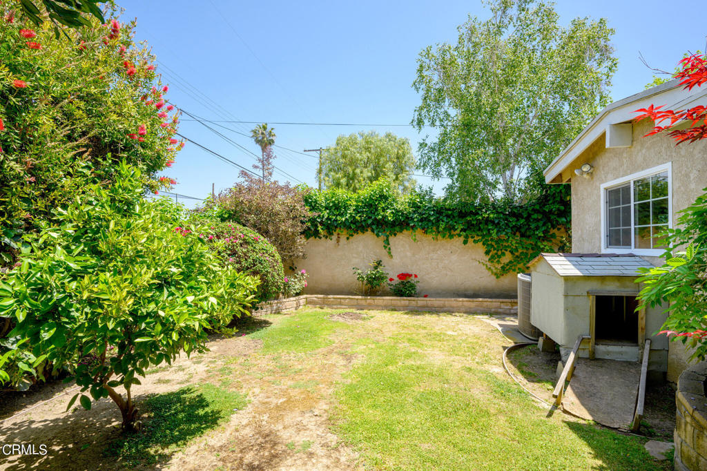17149 Bullock Street Encino, CA 91316 - Photo 32 of 32 a view of a patio with table and chairs potted plants and large tree