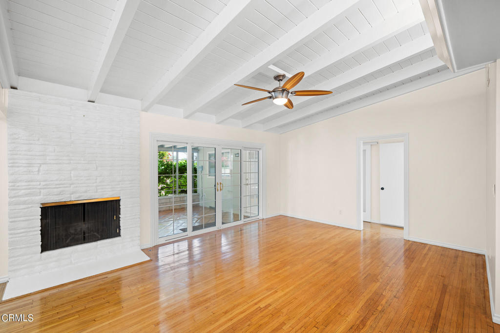 17149 Bullock Street Encino, CA 91316 - Photo 7 of 32 wooden floor in an empty room with a fireplace