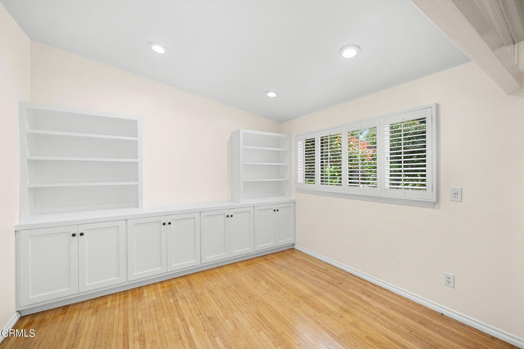 17149 Bullock Street Encino, CA 91316 - Photo 9 of 32 a view of an empty room with wooden floor and a window